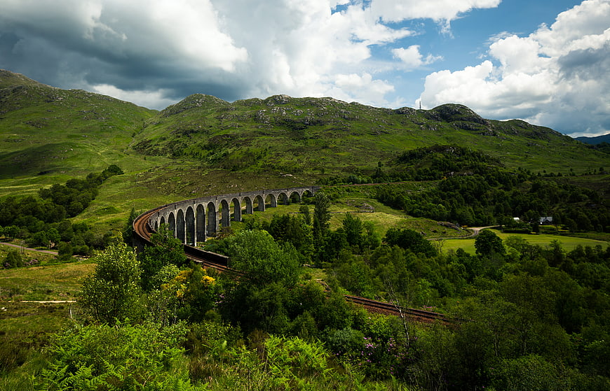 Glenfinnan Viaduct in Scottish Highlands with Green Hills