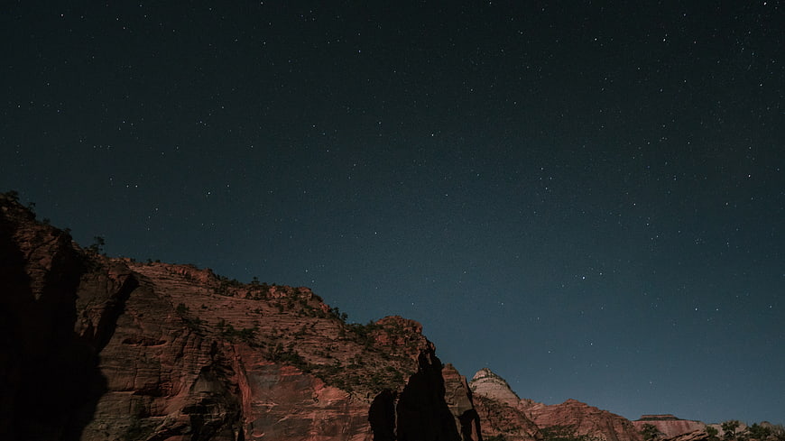 Starry Night Sky Over Red Rock Desert Landscape