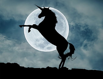 Silhouette of a rearing unicorn against a large full moon in a cloudy night sky
