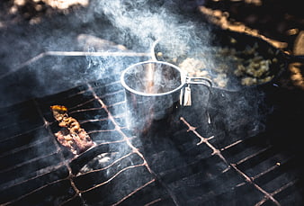 Smoky Campfire Cooking with Metal Mug and Bacon
