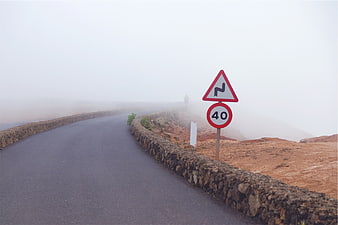 Foggy Mountain Road with Speed Limit Sign