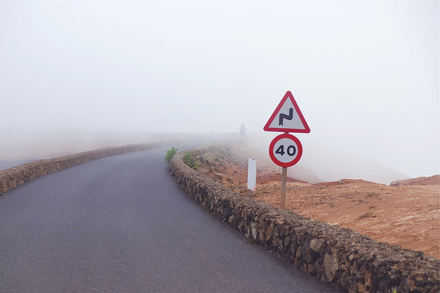 Foggy Mountain Road with Speed Limit Sign