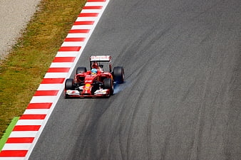 Red Formula 1 Race Car Cornering on Asphalt Track