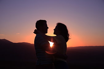 Silhouette of Romantic Couple Embracing at Sunset