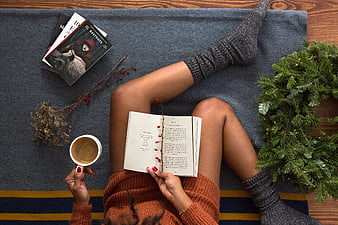 Cozy Holiday Reading Scene With Coffee, Books, And Christmas Wreath