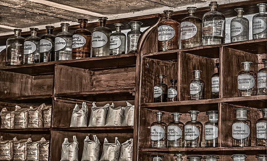 Antique Apothecary Shelves with Vintage Glass Medicine Bottles