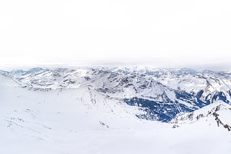 Snowy Alpine Mountain Panorama with Overcast Sky