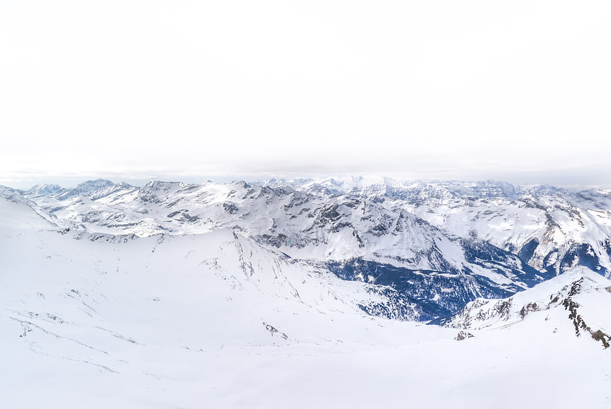 Snowy Alpine Mountain Panorama with Overcast Sky