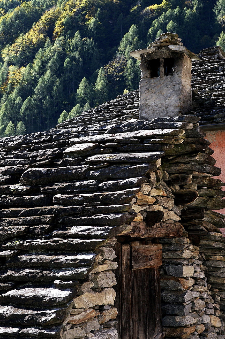 Rustic stone roof and chimney in Swiss Alps