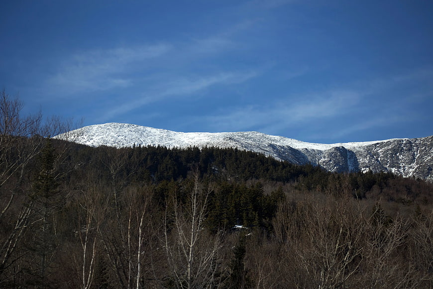 Snow-Capped Mountain Ridge Above Winter Forest