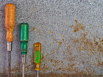 Vintage Screwdrivers on Rusty Metal Background