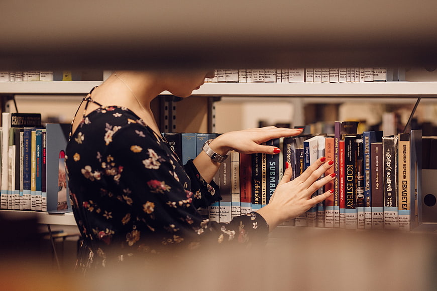 Woman browsing books in a library