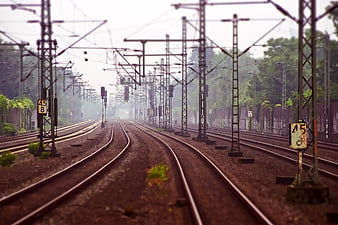 Empty railway tracks with overhead wires and signals