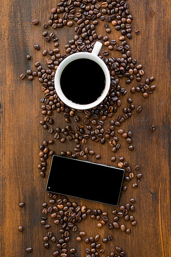 Top View of Coffee Cup and Smartphone on Wooden Table with Beans