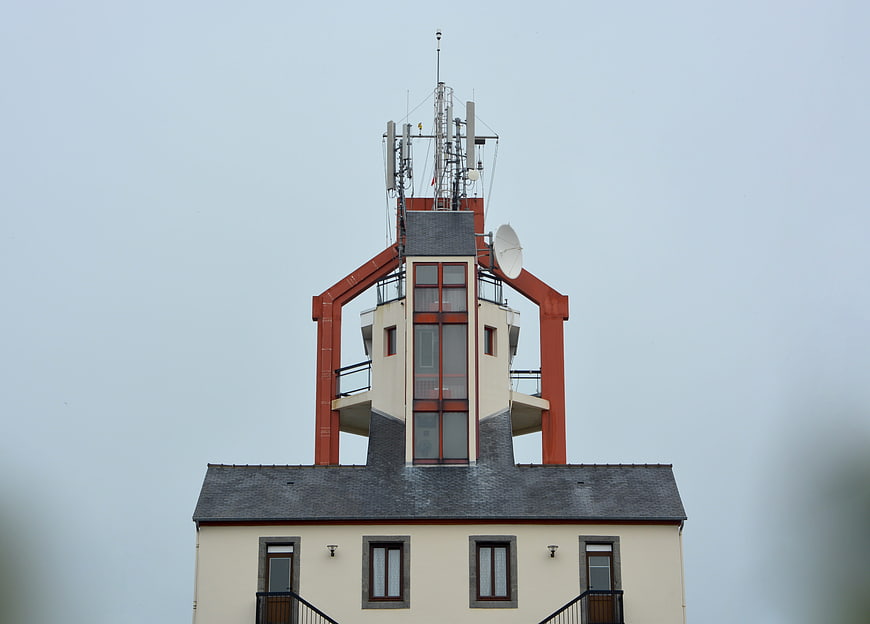 Historic Semaphore Tower With Modern Antennas Against Overcast Sky