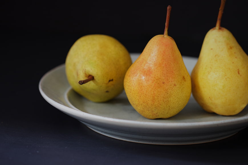 Three Fresh Pears on a Ceramic Plate
