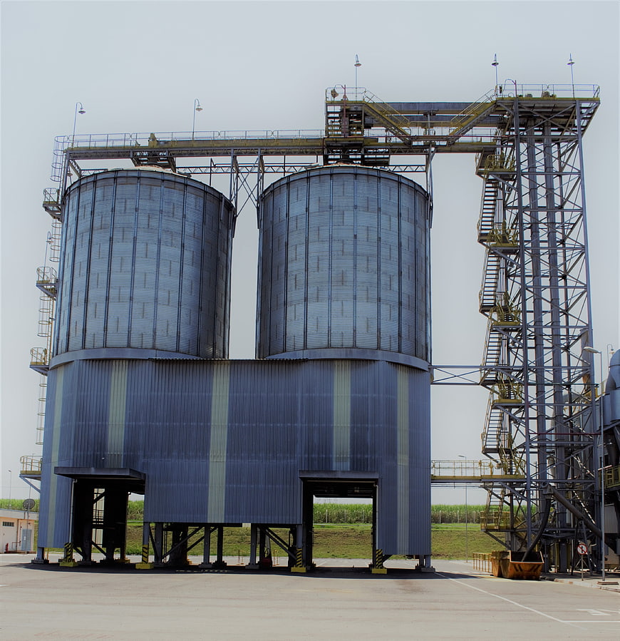 Large industrial grain silos with metal framework and stairs