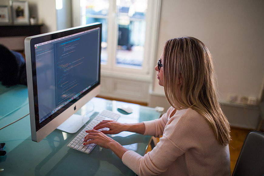 Woman Coding on Desktop Computer in Home Office