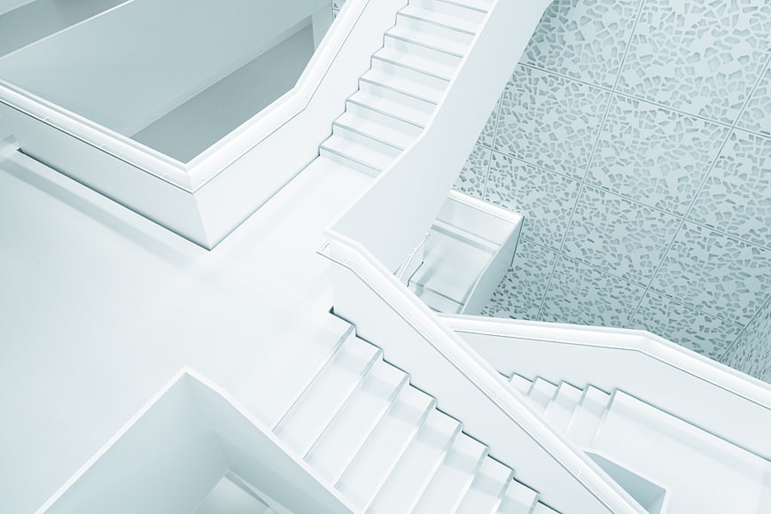 Minimalist White Staircase with Geometric Patterns
