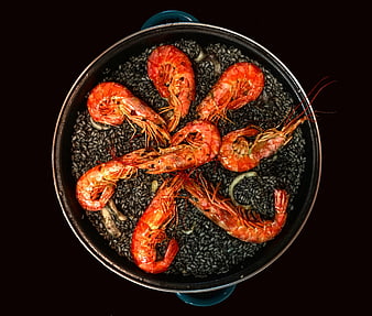 Overhead View of Black Rice Paella with Shrimp in a Dark Pot