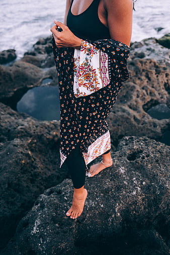 Woman in Boho Coverup Standing on Coastal Rocks