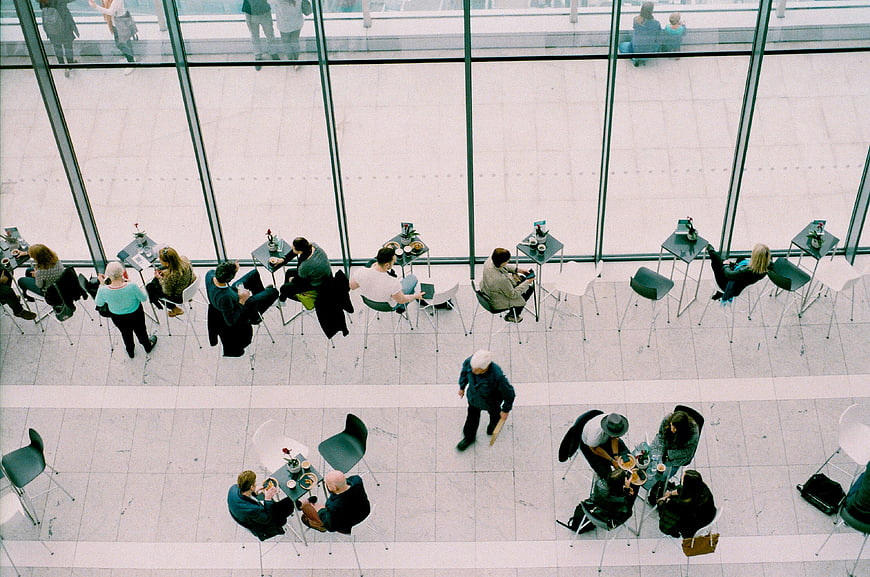High angle view of people dining in modern glass atrium
