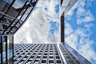 Low angle view of modern skyscrapers against blue sky
