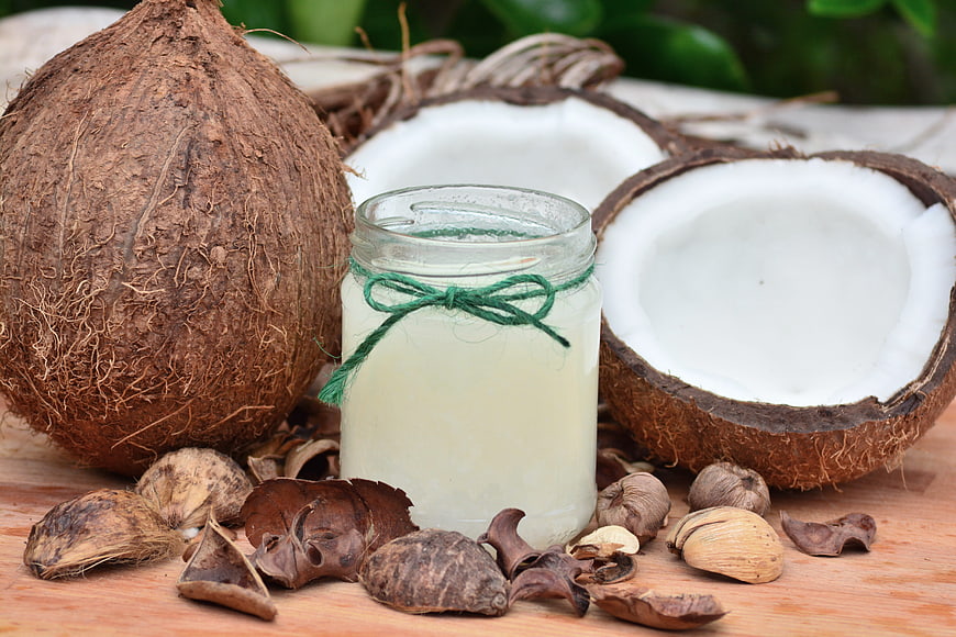 Natural Coconut Oil in Glass Jar with Fresh Coconuts