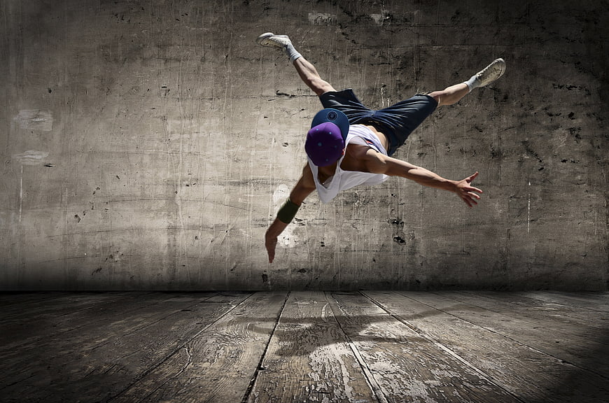 Male Breakdancer Performing Aerial Move in Urban Studio