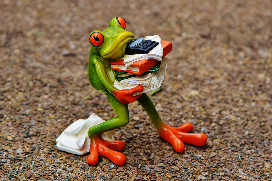 Green Frog Figurine Holding Stack of Papers and Calculator