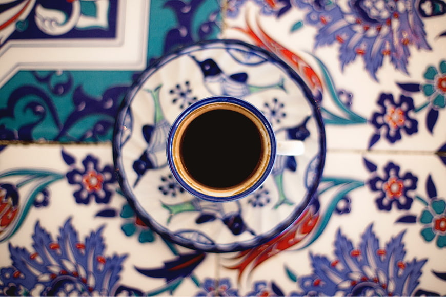 Overhead View of Coffee Cup on Decorative Ceramic Tile