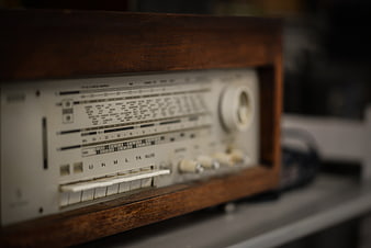Close-up of vintage wooden radio with analog dials