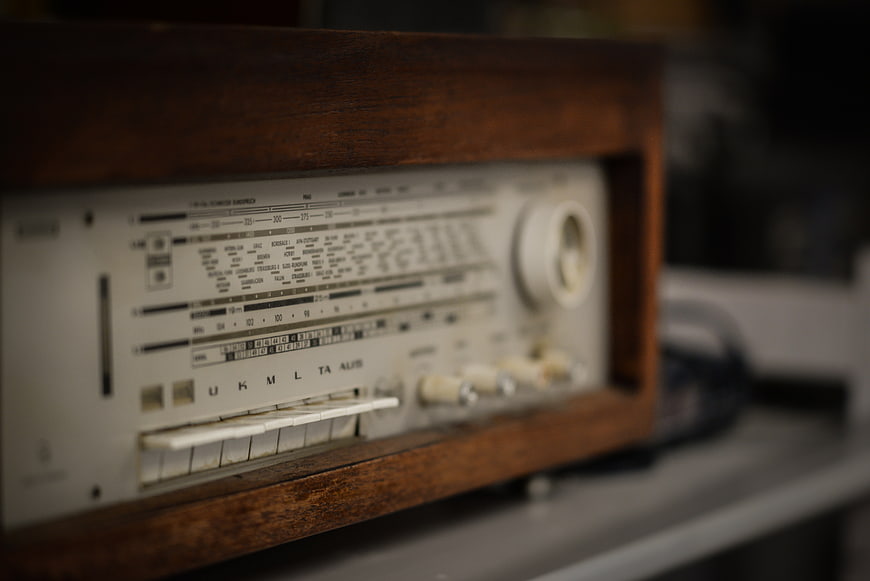 Close-up of vintage wooden radio with analog dials