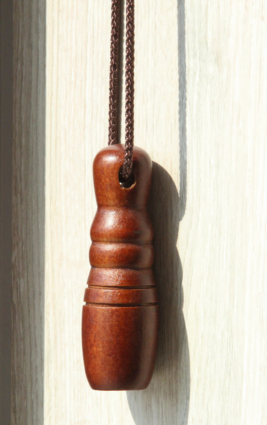 Close-up of wooden camera lens shutter handle on light wood