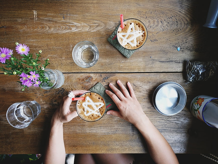 Top view of Vietnamese egg coffee with star latte art on wooden table