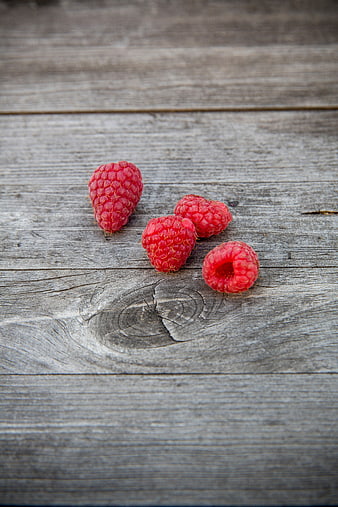 Fresh Raspberries on Weathered Wooden Surface