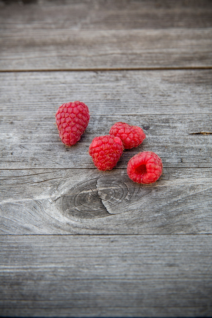 Fresh Raspberries on Weathered Wooden Surface