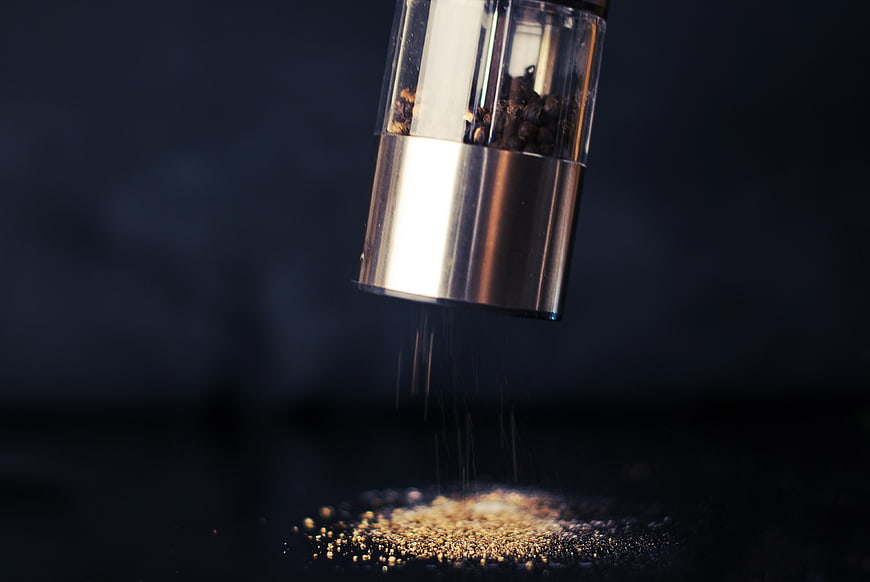 Freshly Ground Black Pepper Falling from Shaker