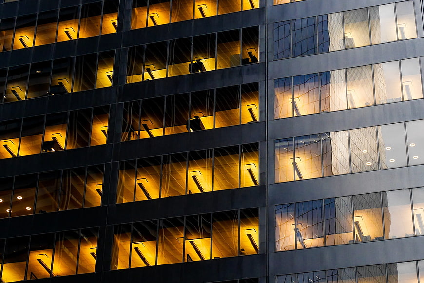 Modern office building facade with warm interior lights