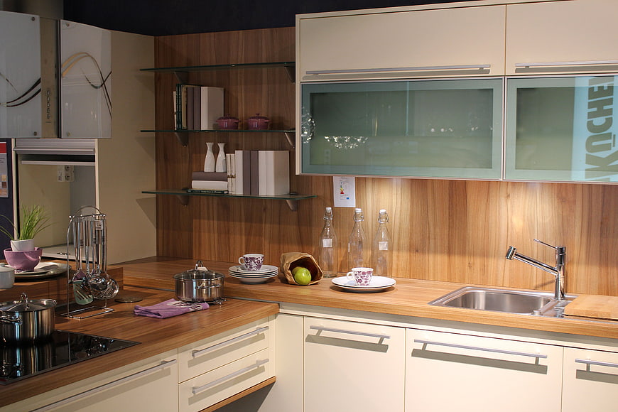 Modern Kitchen Interior With Wooden Countertops And Cream Cabinets