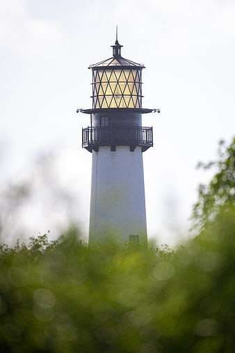 White Lighthouse Tower with Glowing Lantern Room