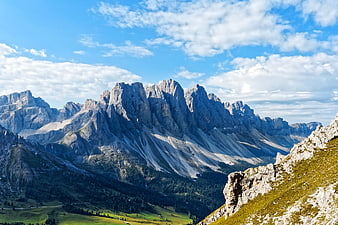 Dramatic Dolomite Mountain Peaks with Green Valley and Blue Sky