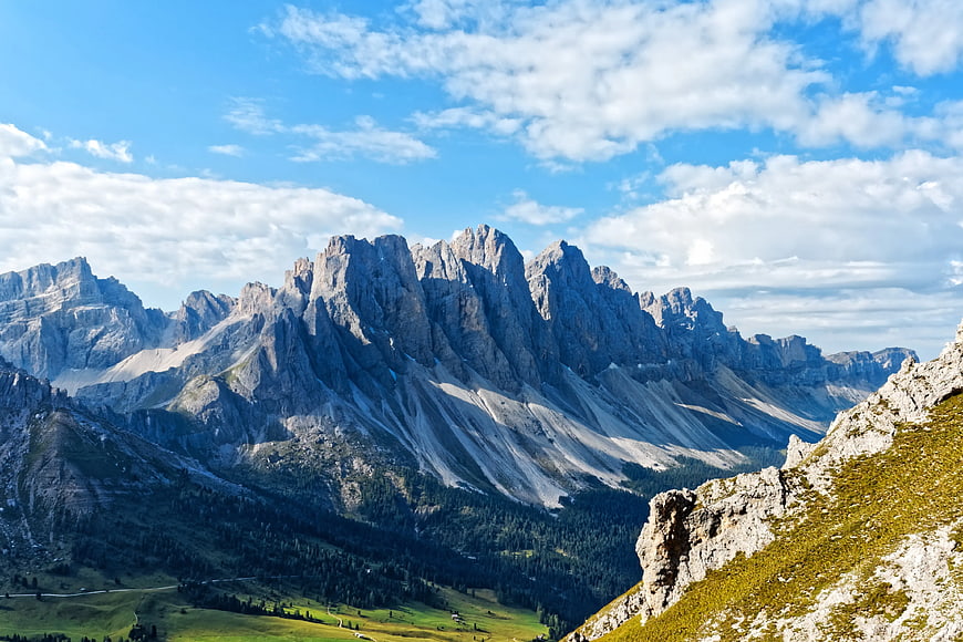 Dramatic Dolomite Mountain Peaks with Green Valley and Blue Sky