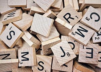 Scattered Wooden Scrabble Tiles with Letters