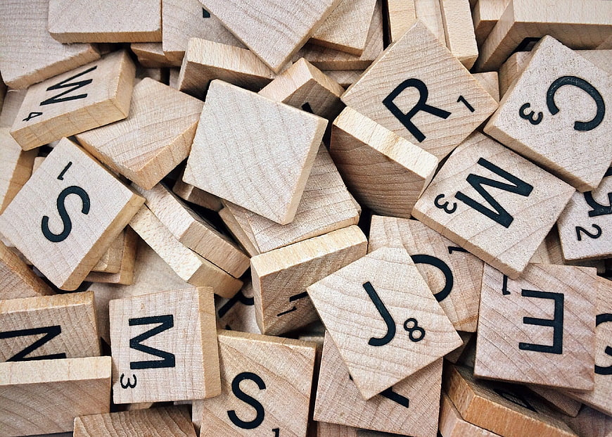 Scattered Wooden Scrabble Tiles with Letters