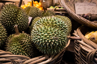 Fresh Spiky Durian Fruit in Wicker Basket at Market