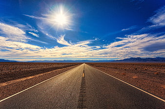 Endless Desert Highway Under Bright Blue Sky