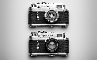 Two vintage Zorki 4 film cameras on gray background