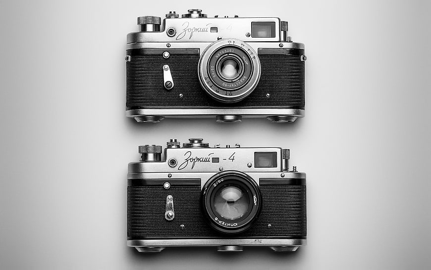 Two vintage Zorki 4 film cameras on gray background