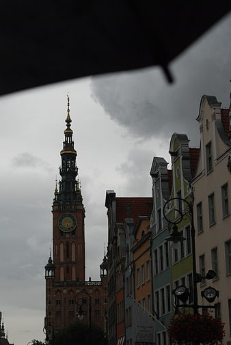 Gdansk Town Hall Tower and Colorful Buildings Under Rainy Sky
